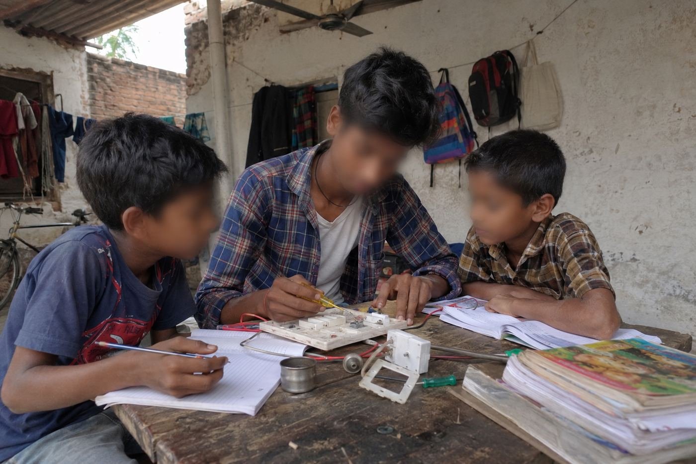 Vikas teaching younger students electrical skills